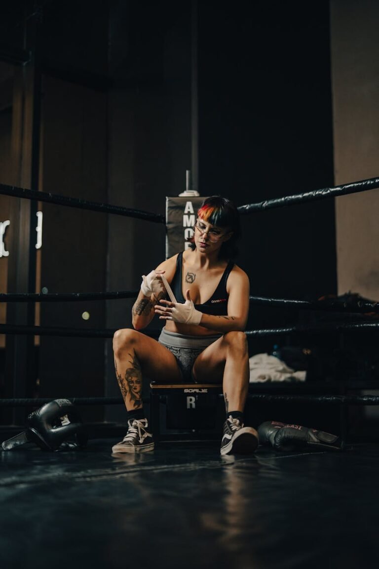 female boxer in training resting in gym