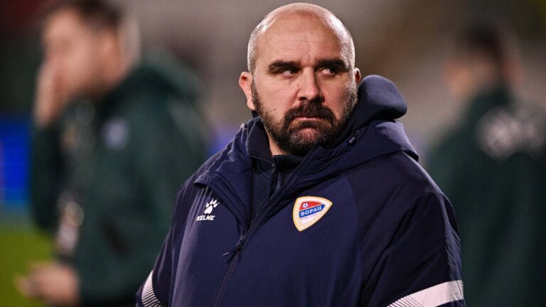 A Serbian league coach has died after collapsing mid-match