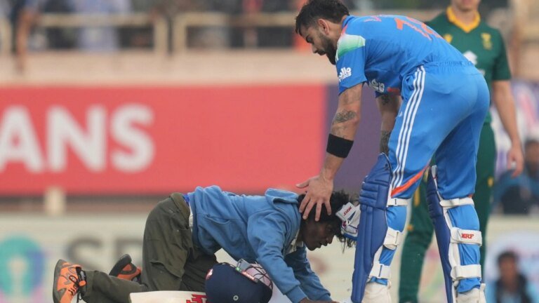 A Virat Kohli fan evades security, falls at his feet and interrupts the hundred celebration