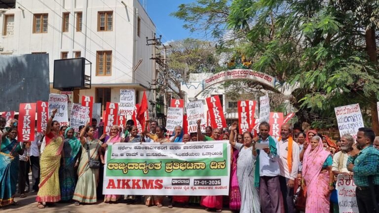 Hundreds of daily wage laborers take part in a protest march in Dharwad