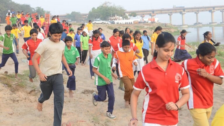 Children lead a No-Plastic run on the banks of the Krishna River