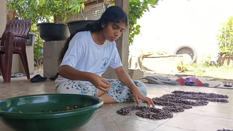 A young eco-enthusiast turns the floor into a canvas to spread the message of traditional seed conservation