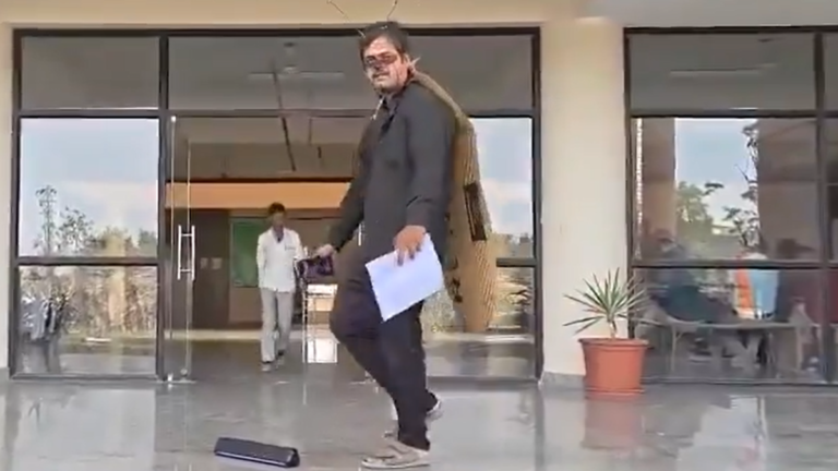 A man reaches the Mathura civic association office dressed as a cockroach to draw attention to the pollution of the Yamuna