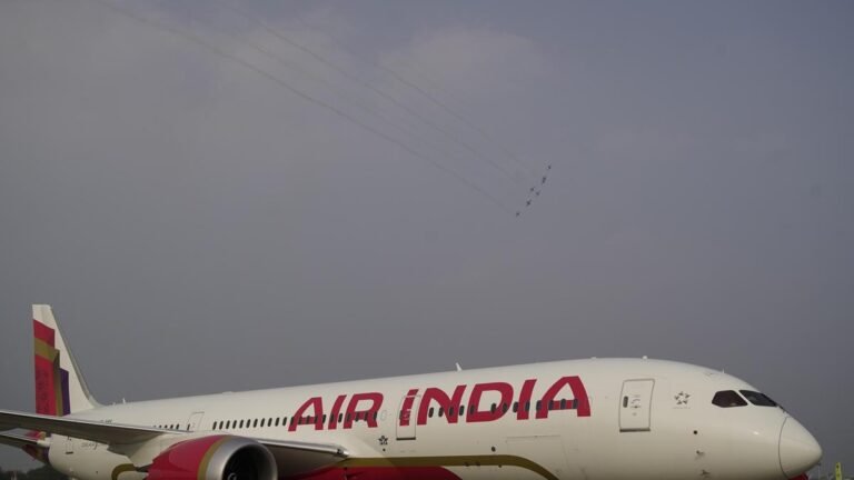 An Air India plane arrives ahead of an IndiGo plane on the same taxiway at Ahmedabad airport