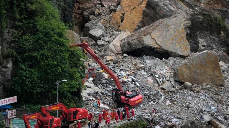 Rescuers scramble in the rain to find survivors after a landslide in China killed at least eight people