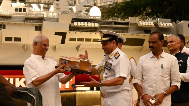 The Navy hands over a model of INS Vikrant to the capital